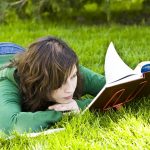 Woman with book reading in the park.