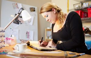 Young Woman Scrapbooking At Home